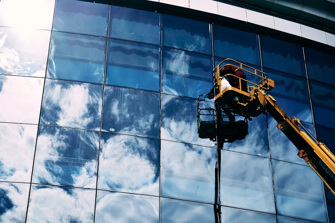 A close-up view of a professional wearing full protective equipment while disinfecting an indoor surface.